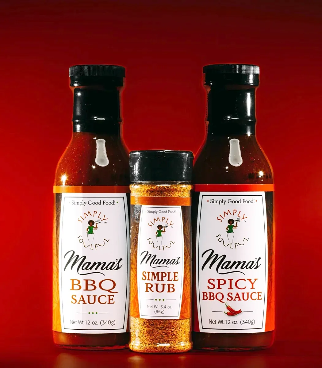 Three Simply Soulful bottles on a red background &mdash; Mama&rsquo;s BBQ Sauce, Mama&rsquo;s Simple Rub and Mama&rsquo;s Spicy BBQ Sauce.